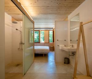 a bathroom with a bed and a sink in a room at Abeiro da loba 