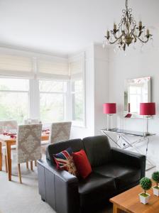 a living room with a black couch and a table at Valley View in Harrogate