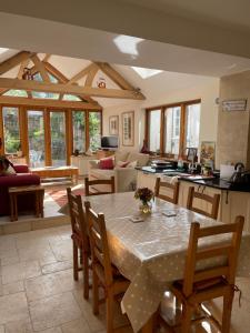 a kitchen and living room with a table and chairs at Prospect Cottage in Box