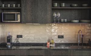 a kitchen with a counter top with a microwave at Black Beach Suites in Vík +37 photos
