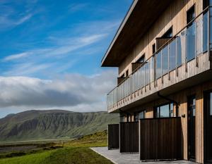 a building with a view of the mountains at Black Beach Suites in Vík