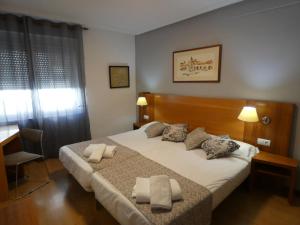 Ένα ή περισσότερα κρεβάτια σε δωμάτιο στο Hotel Mercado by gaiarooms