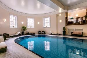 a large swimming pool in a large room with at Doxford Hall Hotel And Spa in Chathill