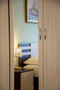 a bedroom with a bed and a table with a lamp at Irini Apartments in Kavala