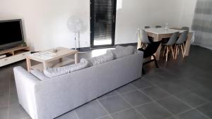 a living room with a couch and a table at Maison entière moderne tout confort de 92m² in Angoulême