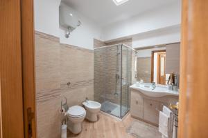 a bathroom with a toilet and a sink and a shower at Casa Antonia in Anacapri