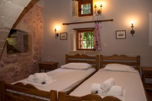 A bed or beds in a room at STAMATOGIANNIS Traditional Apartments