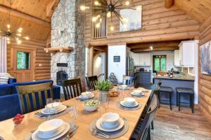 a dining room and kitchen with a table in a cabin at LOG CABIN w HOT TUB, BEACH access, near of TREMBLANT in Labelle