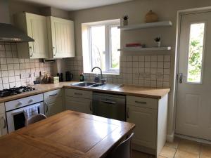 a kitchen with a sink and a wooden table at Springfield in Oakham