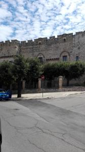 a large brick building with a stop sign on a street at B&B CASAVACANZE CHIESA MADRE in Carovigno