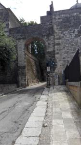 an old stone building with an archway on a street at B&B CASAVACANZE CHIESA MADRE in Carovigno