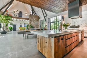 a large kitchen with a large island in a room at Het Lichthuis in Zandvoort