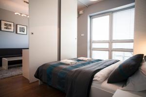 a bedroom with a bed and a large window at Platinum Towers Luxury Apartments in Warsaw