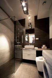 a bathroom with a sink and a toilet at Platinum Towers Luxury Apartments in Warsaw