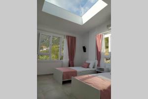 a bedroom with two beds and a skylight at muda apart kalkan in Kalkan