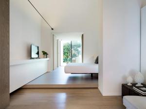 a bedroom with white walls and a bed in a room at Zash Country Boutique hotel & SPA in Giarre