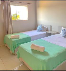 a room with two beds with towels on them at Canarias Bed & Breakfast in San Lorenzo