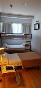 two bunk beds in a room with a window at Hotel Ciudad de Corella in Corella