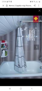 a bathroom with a bath tub with a shower curtain at Pid lisochkom in Verkhovyna +105 photos