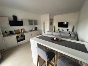 a kitchen and living room with a table and chairs at Sweet Home am Arendsee in Arendsee