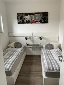 a room with two beds and a sink and a mirror at Sweet Home am Arendsee in Arendsee