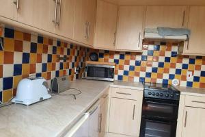 a kitchen with a stove and a microwave in it at Never to be booked in York