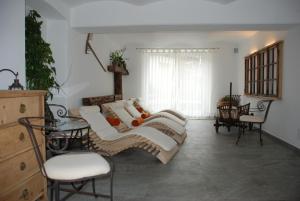 a living room with white furniture and a table and chairs at Aparthotel Pichler in Colle Isarco