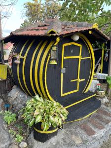 a small house with a door and some plants at Angelinin Konak in Negotin