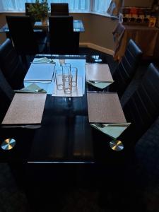 a table in a restaurant with glasses on it at The Vale Apart Hotel in Hull