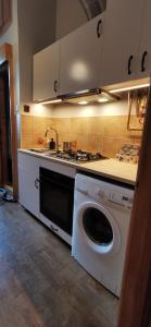 eine Küche mit einer Waschmaschine und einem Waschbecken in der Unterkunft Chojnice - mieszkanie w kamienicy in Chojnice