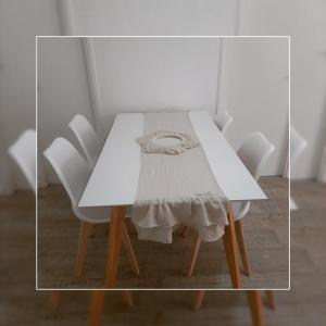 a white table with four white chairs around it at Depto.shanti-guemes Mar del Plata in Mar del Plata