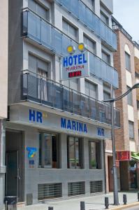 a hotel with a sign on the front of a building at Hotel Marina in Peñíscola