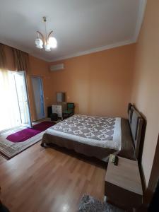 a bedroom with a bed and a large window at Kemeni Gardens in Batumi