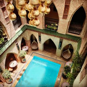 an overhead view of a swimming pool in a building at Riad Challa Hotel & Spa in Marrakesh