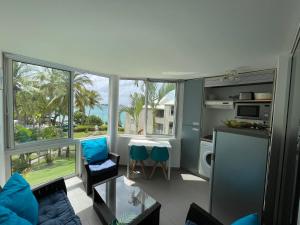 a kitchen and living room with a view of the ocean at Résidence de la Vieille Tour in Le Gosier