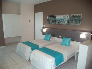 Postel nebo postele na pokoji v ubytování Blue Nest Hotel