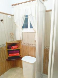 a bathroom with a shower and a toilet and a window at Casa Los Álamos in Breña Alta