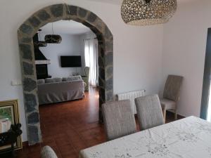 a living room with an archway and a table and chairs at Cortijo El Aire, Parque Natural Cabo de Gata in El Pozo de los Frailes