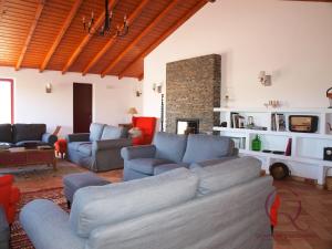 a living room with a couch and chairs and a fireplace at Quinta de São Gabriel in Castro Marim