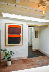 a room with a painting on the wall and a plant at The Parador in Santa Fe