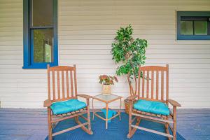 two chairs and a table with a plant on a porch at Historic Tate House Apartment by Marietta Square in Marietta