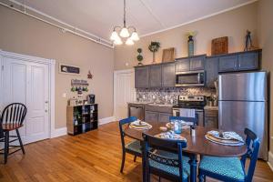 a kitchen with a table and chairs and a refrigerator at Historic Tate House Apartment by Marietta Square in Marietta