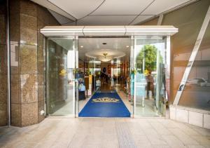 a glass door of a building with a blue floor at APA Hotel Kanazawa Ekimae in Kanazawa