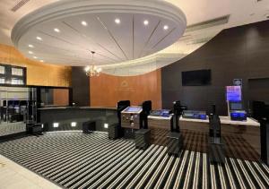 a lobby with a bowling alley with black chairs at APA Hotel Kanazawa Ekimae in Kanazawa