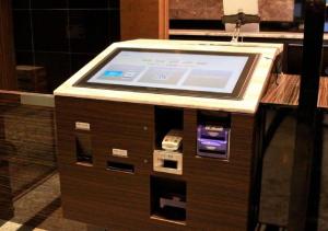 a kiosk with a computer screen on top of it at APA Hotel Kanazawa Ekimae in Kanazawa