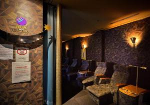 a waiting room with chairs and a sign on the wall at APA Hotel Kanazawa Ekimae in Kanazawa