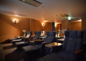 a waiting room with blue chairs and a waiting room at APA Hotel Kanazawa Ekimae in Kanazawa