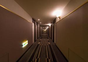 a long hallway with a bench in a building at APA Hotel Kanazawa Ekimae in Kanazawa