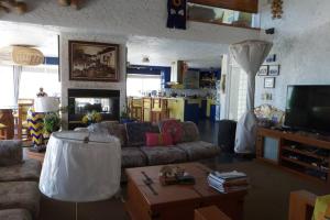 a living room with a couch and a coffee table at CASA DE PLAYA EN ENSENADA in Ensenada