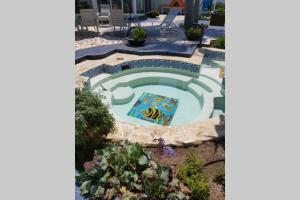 a swimming pool with a mosaic in a garden at CASA DE PLAYA EN ENSENADA in Ensenada